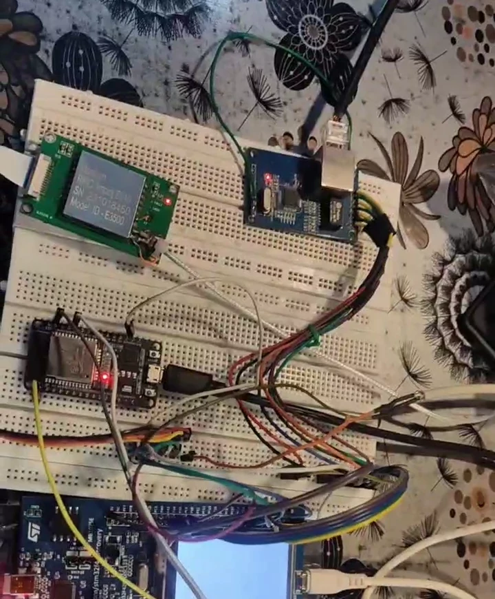The real prototype: an STM32 development board, ESP32 module and RFID reader wired together on a breadboard.